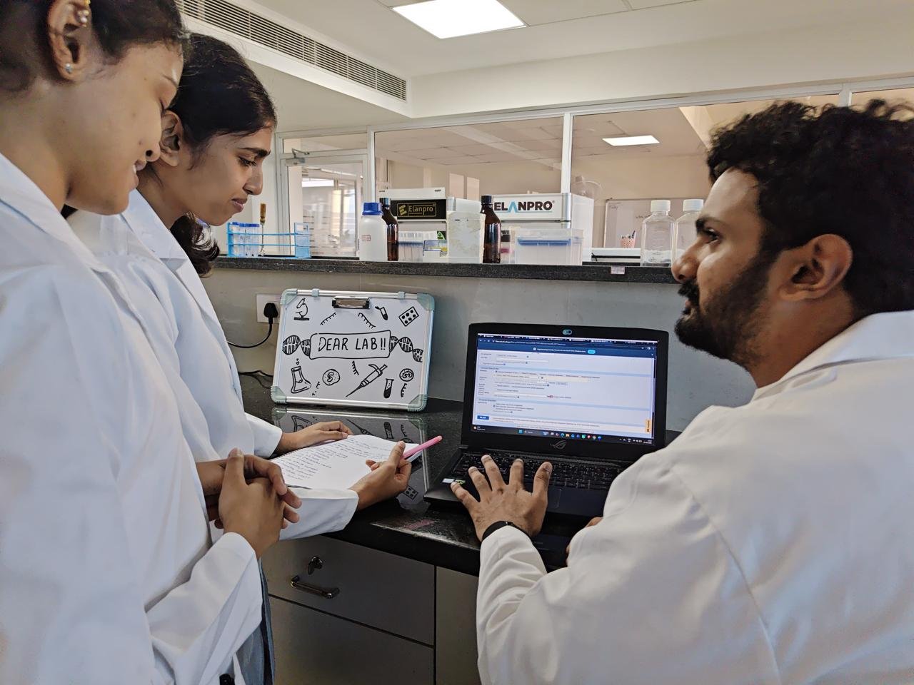 DEAR Lab members reviewing results on a laptop